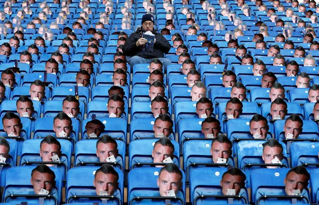 A fan takes his seat surrounded by paper masks of Leicester's Jamie Vardy prior to kickoff during the Premier League match between Leicester City and Everton at The King Power Stadium on December 26, 2016 in Leicester, England. (Photo by Carl Recine/Reuters/Action Images/Livepic)