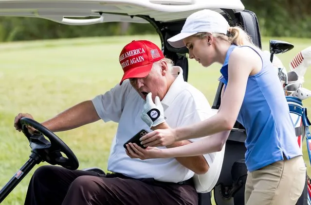 A staffer shows former US President Donald J. Trump a poll comparing his popularity to former US Vice President Mike Pence during a Pro-Am tournament leading up to the LIV Golf Bedminster invitational, part of the new LIV Golf Invitational Series, at the Trump National Golf Club in Bedminster, New Jersey, USA, 28 July 2022. The tournament will be held from 29 – 31 July. (Photo by Justin Lane/EPA/EFE)