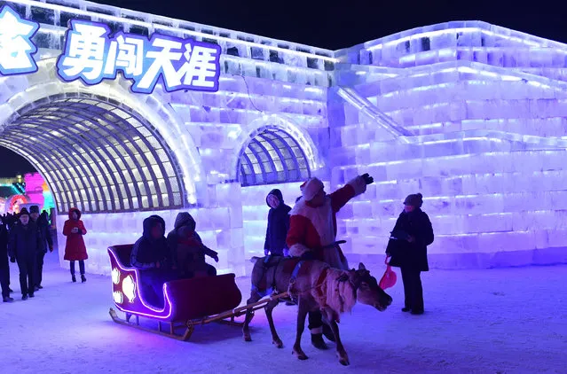 People visit the Ice-Snow World park in Harbin, capital of northeast China's Heilongjiang Province, January 5, 2017. (Photo by Xinhua/Barcroft Images)