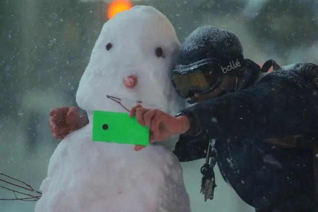 A man takes a selfie with a snowman during a snow storm in Times Square in the Manhattan borough of New York, January 23, 2016. (Photo by Carlo Allegri/Reuters)