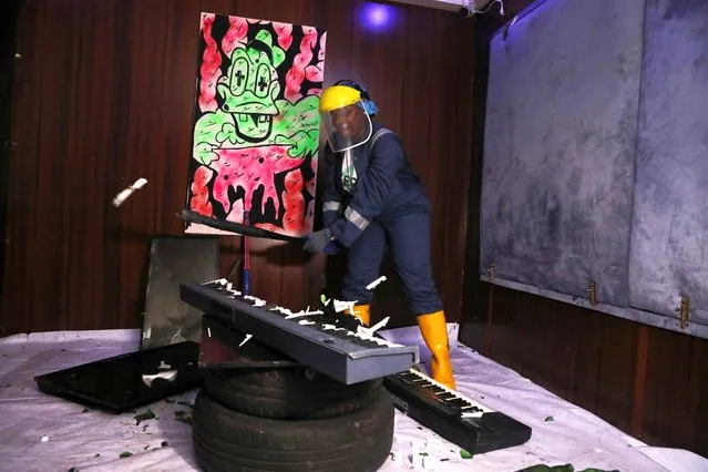 Nancy Igwe smashes a musical keyboard at the Shadow rage room, a place where people can destroy objects to vent anger, in Lagos, Nigeria on November 21, 2023. (Photo by Temilade Adelaja/Reuters)