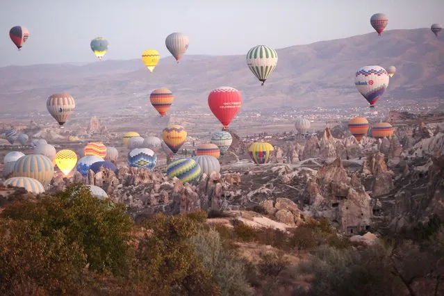 A general view of hot air balloons, almost 556,306 local and foreign tourists get on within January-October period of this year, gliding over the historical Cappadocia, which is on the UNESCO World Heritage List, in Nevsehir, Turkiye on November 7, 2023. (Photo by Behcet Alkan/Anadolu via Getty Images)