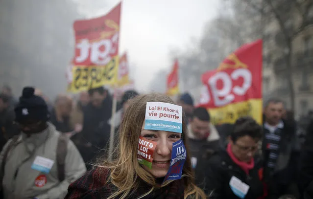 Protestors and French labour union workers, attend a demonstration against the French labour law proposal in Paris, France, as part of a nationwide labor reform protest, March 9, 2016. The slogan reads “El Khomri law, a rotten life”. (Photo by Christian Hartmann/Reuters)