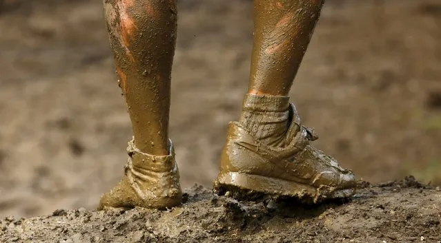 A competitor is seen only wearing one shoe as he participates in the Tough Mudder challenge near Henley-on-Thames in southern England May 2, 2015. (Photo by Eddie Keogh/Reuters)