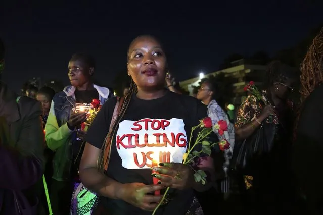 Women hold candles and flowers during a “Dark Valentine” vigil to demonstrate against the rising cases of femicide, in downtown Nairobi, Kenya, Wednesday, February 14, 2024. According to Kenya police, at least 16 women are thought to have been killed by their partners since the beginning of this year. (Photo by Brian Inganga/AP Photo)