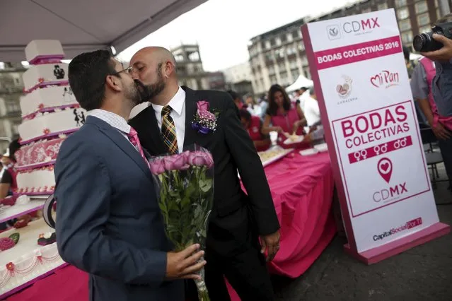 A couple kiss after a mass wedding ceremony in which 2,016 couples participated, at Zocalo square in Mexico City, Mexico, March 19, 2016. (Photo by Edgard Garrido/Reuters)