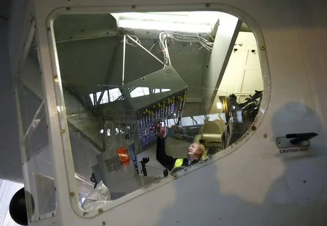 Test pilot David Burns sits in the cockpit of the Airlander 10 hybrid airship during its unveiling in Cardington, Britain March 21, 2016. (Photo by Darren Staples/Reuters)