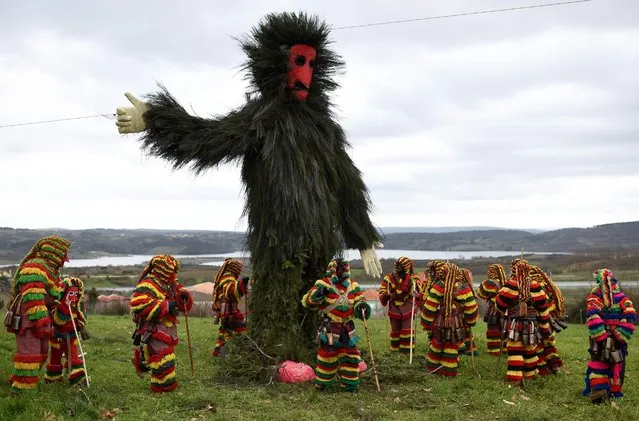 Participants dressed up as “Caretos” gather around a giant effigy made of broom, that finally will be burnt, as they take part in Podence carnival, near Macedo de Cavaleiros in northeastern Portugal on February 7, 2016. (Photo by Francisco Leong/Getty Images)