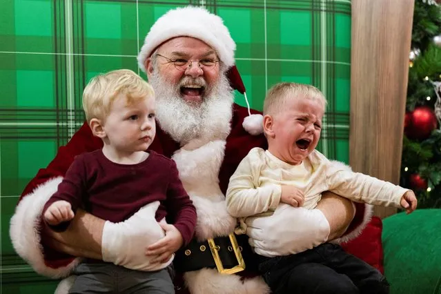 Brantley O'Hanlon, 2, and Christian Malseed, 2, pose for a photo with Santa at the Willow Grove Park Mall ahead of Christmas in Willow Grove, Pennsylvania, U.S. December 3, 2021. (Photo by Hannah Beier/Reuters)