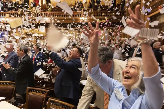 State representatives throw paper in the air to celebrate the end of the legislative session at the House of Representatives in the Capitol in Atlanta on Sine Die, Thursday, March 28, 2024. (Photo by Arvin Temkar/Atlanta Journal-Constitution via AP Photo)