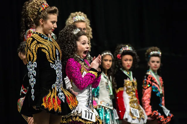 An Irish dancer celebrates in front of her competitors after winning the under 14's World Irish Dance Championship on April 2, 2016 in Brighton, England. The 8th World and 11th European Irish Dance Championships sees over 1500 dancers from 26 countries, speaking over 20 languages, competing in a variety of contests at the Brighton Centre on the city's beachfront. The event is organised by the World Irish Dance Association and is billed as the “Irish Dance Spectacular”. (Photo by Chris Ratcliffe/Getty Images)