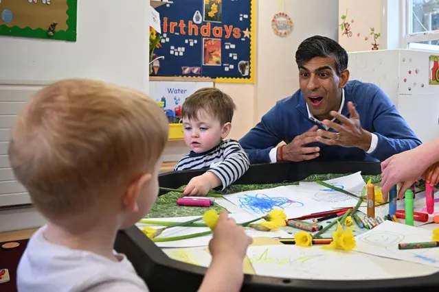 Britain's Prime Minister Rishi Sunak interacts with children during a visit to Aldersyde Day Nursery in Hartlepool, north east England on April 2, 2024. Sunak said on Monday that his Government was delivering on its childcare plan, as the first parents in England benefited from taxpayer-funded care for two-year-olds. (Photo by Paul Ellis/Pool via AFP Photo)