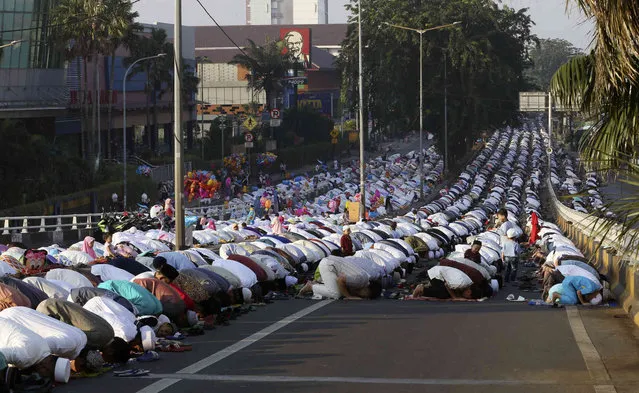 Indonesian Muslims perform Eid al-Fitr prayer that marks the end of the holy fasting month of Ramadan in Jakarta, Indonesia, Wednesday, June 5, 2019. (Photo by Achmad Ibrahim/AP Photo)