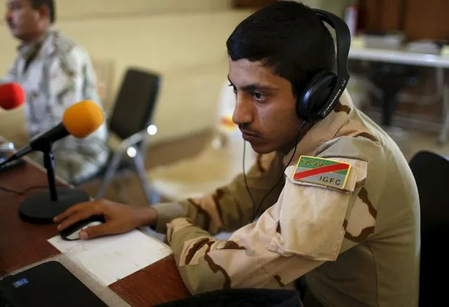 An Iraqi soldier works at a radio station at Makhmour base, Iraq April 17, 2016. (Photo by Ahmed Jadallah/Reuters)