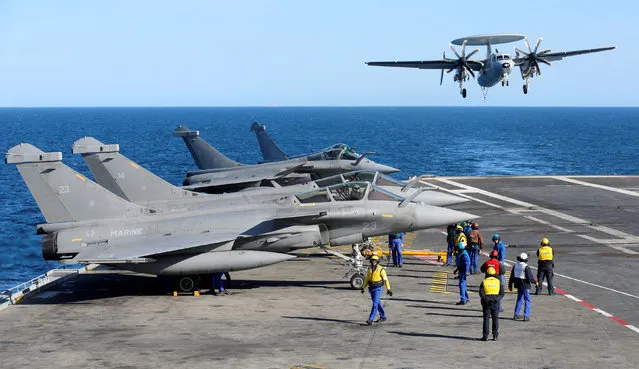 A Hawkeye aircraft lands on the French aircraft carrier Charles de Gaulle in the Mediterranean sea, March 5, 2019. (Photo by Jean-Paul Pelissier/Reuters)