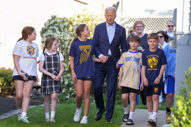 President Joe Biden walks out of his childhood home with a group of unidentified children, Tuesday, April 16, 2024, in Scranton, Pa. (Photo by Alex Brandon/AP Photo)