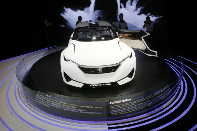 Visitors gather around a Peugeot Fractal electric coupe car during Auto China 2016 auto show in Beijing April 25, 2016. (Photo by Kim Kyung-Hoon/Reuters)