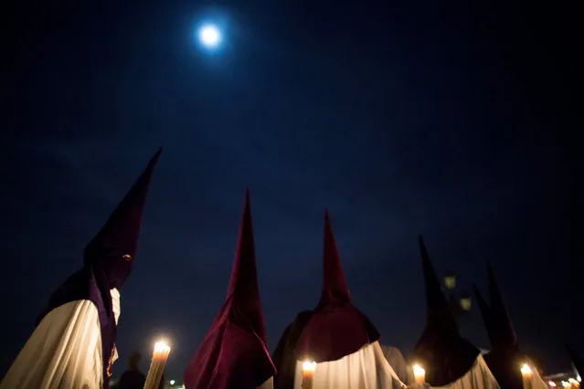 Penitents of “La Estrella” (The Star) brotherhood take part in a procession during Holy Week in the Andalusian capital of Seville, southern Spain April 10, 2017. (Photo by Jesus Moron/Reuters)