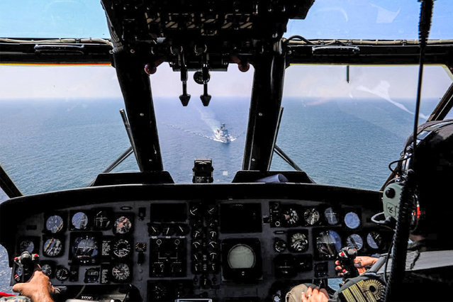 This handout picture provided by the Iranian Army office on March 15, 2023 shows Iranian military helicopter pilots flying their aircraft during joint naval military drills between Iran, Russia, and China in the Gulf of Oman. (Photo by Iranian Army office via AFP Photo)