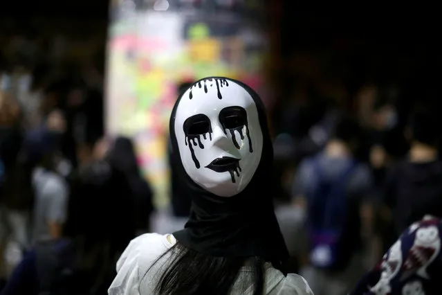 An anti-government protester wears a mask during a demonstration in Wong Tai Sin district, in Hong Kong, China on October 4, 2019. (Photo by Athit Perawongmetha/Reuters)