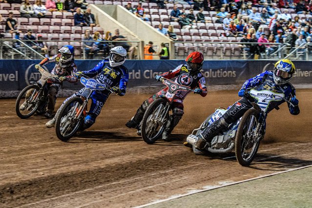 Kings Lynn Stars' Guest Rider Chris Harris in Yellow and Kings Lynn Stars' Niels-Kristian Iversen in White take an early lead over Belle Vue Aces' Jaimon Lidsey in Red and Belle Vue Aces' Jake Mulford in Blue during the Rowe Motor Oil Premiership match between Belle Vue Aces and King's Lynn Stars at the National Speedway Stadium, Manchester on Monday 12th August 2024. (Photo by Ian Charles/MI News)