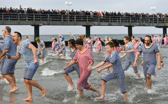 Winter swimmers leave the water after a dip in the Baltic Sea during the traditional New Year swimming in Kuehlungsborn, Germany, January 1, 2020. (Photo by Annegret Hilse/Reuters)