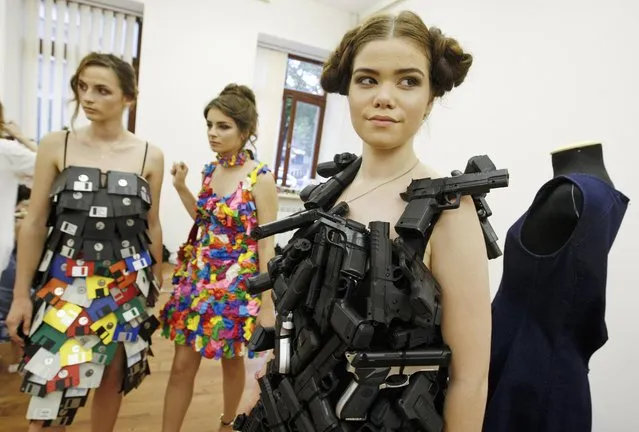 Models wait backstage, during an eco-clothing fashion show from recycled materials by French designer Isagus Toche, in Kiev, Ukraine, on 23 June 2017. (Photo by Stepan Franko/EPA/EFE)