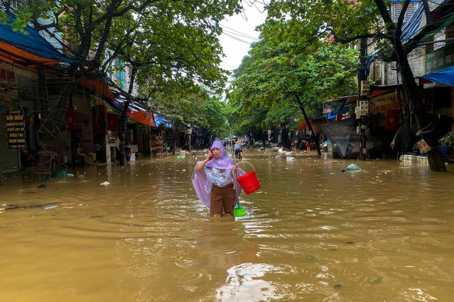 A woman wades through a flooded street following the impact of Typhoon Yagi, in Thai Nguyen City, Vietnam, on September 11, 2024. (Photo by Thinh Nguyen/Reuters)