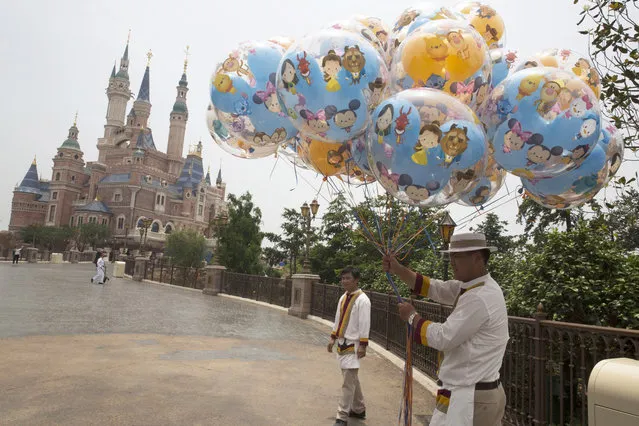 Workers prepare during the eve of the opening of the Disney Resort in Shanghai, China, Wednesday, June 15, 2016. (Photo by Ng Han Guan/AP Photo)