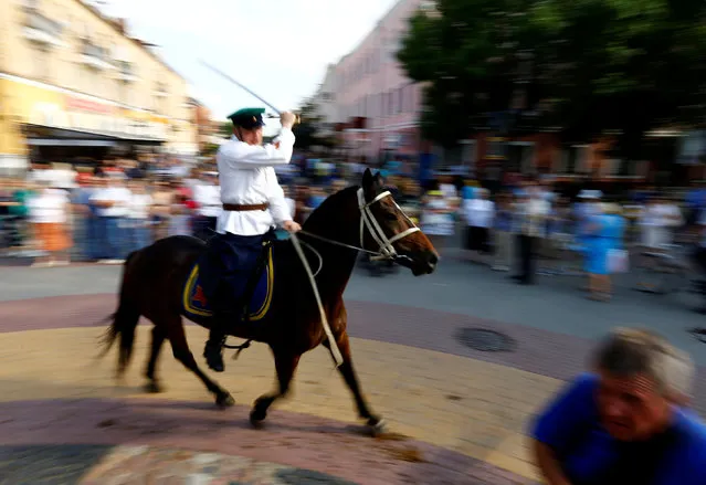 A military enthusiast dressed as World War Two Red Army soldier rides a horse as he marks the 75th anniversary of the Nazi Germany invasion, in Brest, Belarus June 21, 2016. (Photo by Vasily Fedosenko/Reuters)