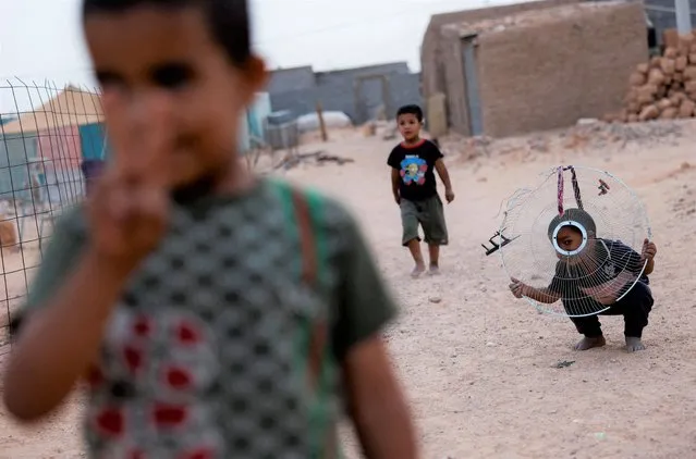 Sahrawi children play at the Smara refugee camp, in Tindouf, Algeria, May 21, 2022. (Photo by Borja Suarez/Reuters)
