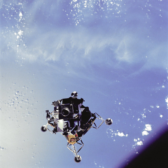 View of the Apollo 9 Lunar Module “Spider”, in a lunar landing configuration, as photographed form the Command/Service Module on the fifth day of the Apollo 9 earth-orbital mission. The landing gear on the Lunar Module has been deployed. Note Lunar Module's upper hatch and docking tunnel. The EVA foot restraints known as the “Golden Slippers” are visible on the porch of the Lunar Module (LM). They allowed Lunar Module pilot Russell “Rusty” Schweickart to securely stand on the porch during his EVA thus allowing him free use of his hands. (Photo by NASA)
