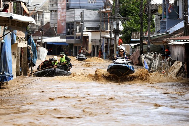 A rescue worker uses jet skis to search for victims in flooded areas in Chiang Rai Province, Thailand, Friday, September 13, 2024. (Photo by Sarot Meksophawannakul/AP Photo)