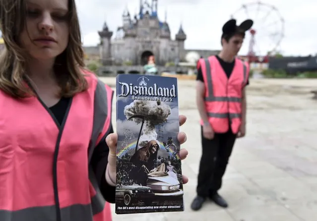 A performer holds a brochure for “Dismaland”, a theme park-styled art  installation by British artist Banksy, at Weston-Super-Mare in southwest England, Britain, August 20, 2015. (Photo by Toby Melville/Reuters)