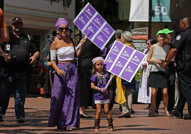 Supporters gather on the pedestrian mall outside the Paramount Theater during a memorial service for Heather Heyer August 16, 2017 in Charlottesville, Virginia. The memorial service was held four days after Heyer was killed when a participant in a white nationalist, neo-Nazi rally allegedly drove his car into the crowd of people demonstrating against the “alt-right” gathering. (Photo by Chip Somodevilla/Getty Images)