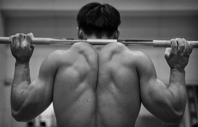 Chinese weightlifter Chen Lijun, who competes in the 62 kg weightclass, warm up during a training session in preparation for the Rio Olympics at the Training Center of General Administration of Sports in China on July 15, 2016 in Beijing, China. (Photo by Kevin Frayer/Getty Images)