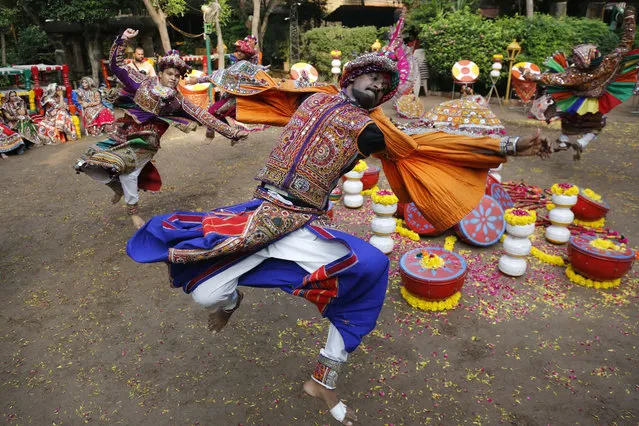 Indians wearing traditional attire practice Garba, a dance of Gujarat state, ahead of Navratri festival in Ahmadabad, India, Monday, September 18, 2017. The Hindu festival of Navratri begins Sept. 21. (Photo by Ajit Solanki/AP Photo)