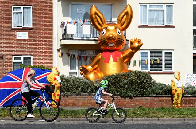 Residents of Belle View Mansions in Southbourne dress up as chickens and erect a huge blow up Easter bunny to show support for the NHS on April 10, 2020 in Bournemouth, United Kingdom. Public Easter events have been cancelled across the country, with the government urging the public to respect lockdown measures by celebrating the holiday in their homes. Over 1.5 million people across the world have been infected with the COVID-19 coronavirus, with over 7,000 fatalities recorded in the United Kingdom. (Photo by Finnbarr Webster/Getty Images)