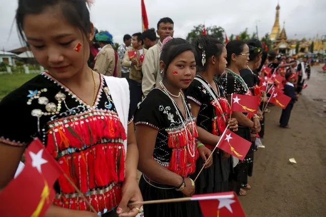 Women of the Yin Net ethnic group wait for the arrival of pro-democracy leader Aung San Suu Kyi at the Hopong township in Shan state, Myanmar September 6, 2015. (Photo by Soe Zeya Tun/Reuters)