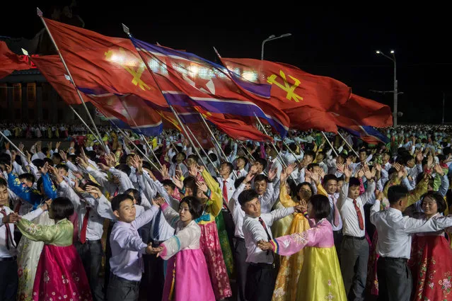 In a photo taken on October 8, 2017 participants described as 'working people, youth, and students of Pyongyang' perform during a mass gala event marking the 20 th anniversary of late North Korean leader Kim Jong Il' s election as general secretary of the Workers' Party of Korea (WPK) on Kim Il- Sung square in central Pyongyang Meanwhile North Korean leader Kim Jong- Un has promoted his sister to a senior ruling party post, state media said, and praised the country' s nuclear weapons programme which has sparked international alarm. (Photo by Kim Won-Jin/AFP Photo)