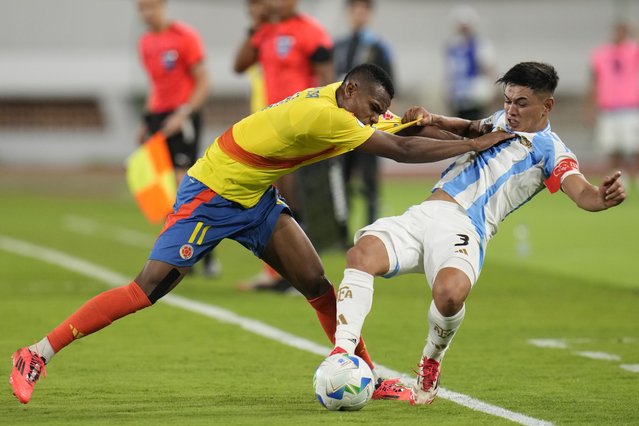 Argentina's Julio Soler, right, and Colombia's Andy Batioja, left, fight for the ball during a South American U-20 Championship final round soccer match in Caracas, Venezuela, Monday, February 10, 2025. (Photo by Matias Delacroix/AP Photo)