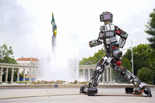 A photo taken on September 27, 2022 shows a 6-metre-tall sculpture made of electronic waste displayed in front of the Heroes' Monument of the Red Army, in Vienna. (Photo by Eva Manhart/APA via AFP Photo)
