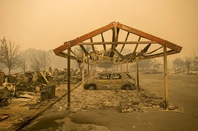 A destroyed vehicle rests under a carport after the Valley Fire raged through Middletown, California September 13, 2015. (Photo by Noah Berger/Reuters)
