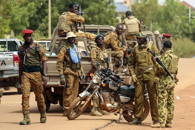 Soldiers loyal to Burkina Faso's latest coup leader Capt. Ibrahim Traore gather outside the National Assembly as Traore was appointed Burkina Faso's transitional president in Ouagadougou, Burkina Faso, Friday October 14, 2022. (Photo by Kilaye Bationo/AP Photo)