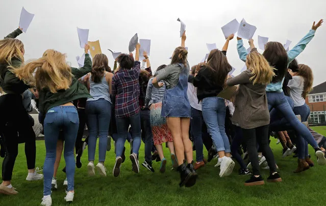 Pupils at Withington Girls' School react as they pose for a school photograph after collecting their GCSE exam results on August 25, 2016 in Manchester, England. Withington Girls' School is an independent girls' school in Fallowfield, Manchester where 72% of pupils taking the GCSE exam achieved A* grades and 95.5% attaining A* to A. Nationally this year's GCSE results for England, Wales and Northern Ireland have shown a significant fall. (Photo by Christopher Furlong/Getty Images)