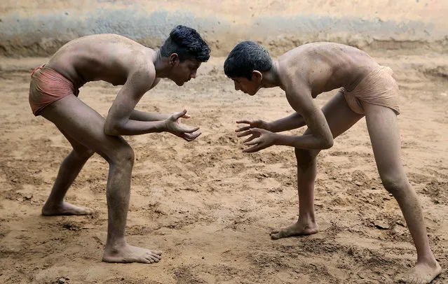 Wrestlers practice on a dirt ground at Maharishi Dayanand Akhara, a traditional wrestling school, in Sarfabad, on the outskirts of New Delhi, India 29 June 2020. According to the Sukhbir Singh, an army veteran and former National wrestler who runs the akhara, around hundred people used to train in his akhara before the coronavirus lockdown. (Photo by Harish Tyagi/EPA/EFE)