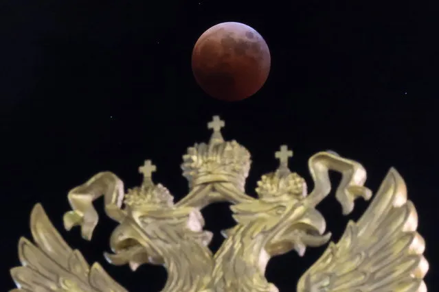 A partial eclipse phase of a total lunar eclipse is seen at night in Vladivostok, Russia on November 8, 2022. The total lunar eclipse, which reached its full phase at 1.59pm Moscow time, could be observed in Russia's Far East, over the Pacific Ocean, in western North America and northern Greenland. (Photo by Yuri Smityuk/TASS)