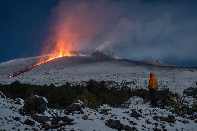 Lava flows from a crater of the Mount Etna volcano late on February 10, 2025. (Photo by Marco Restivo/Etna Walk via AFP Photo)