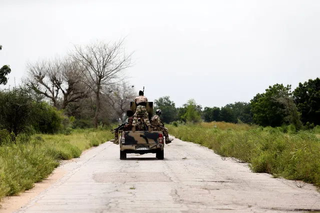 A military vehicle drives along the Konduga-Bama road in Bama, Borno, Nigeria, August 31, 2016. (Photo by Afolabi Sotunde/Reuters)