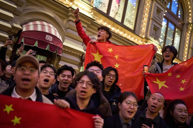 Chinese students greet People's Liberation Army of China soldiers marching along the GUM department store toward Red Square to attend a rehearsal for the Victory Day military parade in Moscow, Russia, on Saturday, May 3, 2025. (Photo by Alexander Zemlianichenko/AP Photo)